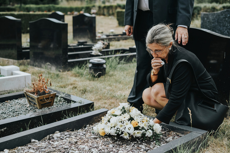 Women grieving at grave site